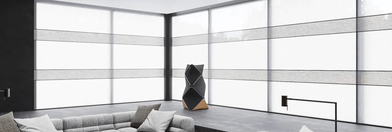Rollo blinds with grey fabric bands on corner floor-to-ceiling windows in a minimalist living room